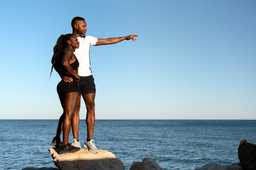 Man showing something at the distance to his woman