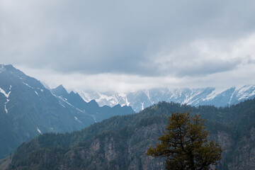 Top of Himalayan High mountains, covered by snow and storm clouds in sky. At Manali, Himachal Pradesh, India. Nature background. 