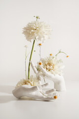 Modern floristry. Art bouquet with white dahlias and white hands. Modern style of floristry