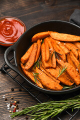 Sweet Potatoes chips on a wooden Background Vegan food 