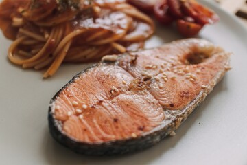 Homemade salmon spaghetti with tomato sauce served for lunch.