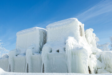 air conditioners outdoors on the background of the sky covered with ice and snow