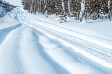 Fototapeta premium climbing road in winter, snowy winter road