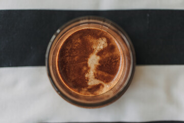 Top view of coffee on milk with beautiful crema.