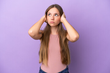 Young Lithuanian woman isolated on purple background frustrated and covering ears