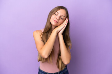 Young Lithuanian woman isolated on purple background making sleep gesture in dorable expression