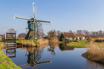 Fototapeta na wymiar Polder windmill 'De Trouwe Waghter', a hollow post mill in Tienhoven in the Netherlands.