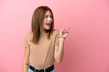 Young English woman isolated on pink background intending to realizes the solution while lifting a finger up