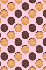 Pattern of cookies. Cookies on a pink background. Flat lay. sandwich cookies filled with sweet cream. Sweet cookies flat lay pattern on light pink background. Top view.