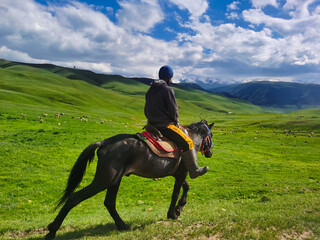 Kazakh farmer on horseback, in the mountains of Almaty region.