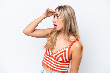 Young caucasian woman isolated on white background with surprise expression while looking side