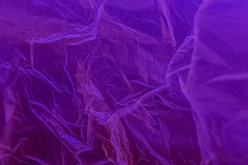 Polyethylene under neon. Plastic texture under ultraviolet light.