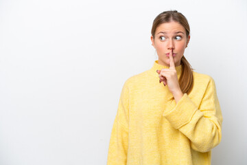 Young caucasian woman isolated on white background showing a sign of silence gesture putting finger in mouth