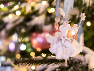 Christmas tree with Snow Queen. Fir tree decorated with light bulbs and ballerina figures for New...