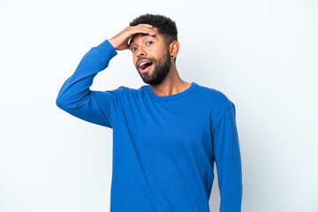 Young Brazilian man isolated on white background doing surprise gesture while looking front