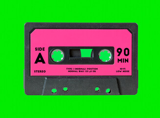 An old vintage cassette tape, isolated on a green background, with some text on the label (Side A,...