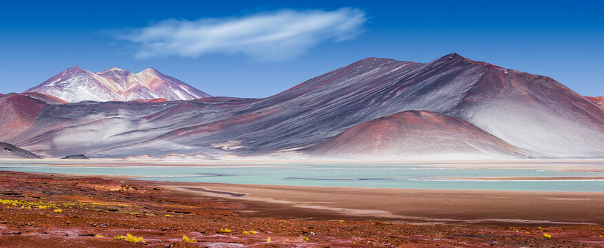 Panorama of a colorful mountain landscape with volcanoes and the salt lake 'Laguna de Talar' in the Andes in the north of Chile 