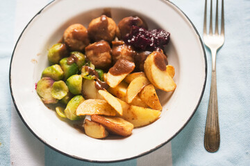 Chicken meatballs with roasted potatoes with brussel sprouts and cabbage 