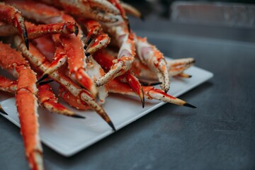Legs of fresh red Kamchatka crab on the table in the restaurant kitchen. Freshly frozen crab meat for cooking