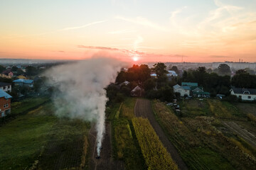 Aerial view of agricultural waste bonfires from dry grass and straw stubble burning with thick...