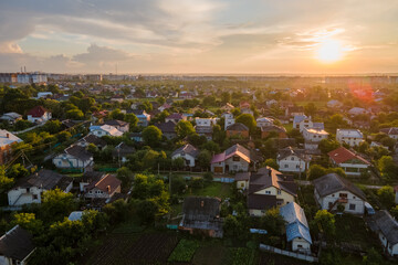 Aerial view of residential houses in suburban rural area at sunset