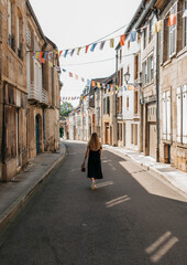 blond woman walking in the street in France, europe.