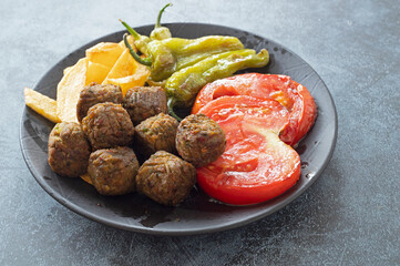 Vegetable patties for vegan burgers in plate, gray marble background.