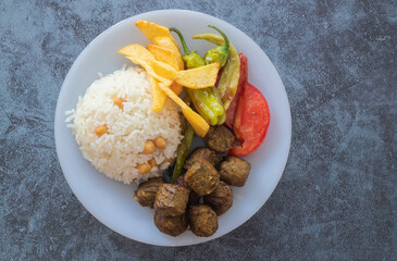Vegetable patties for vegan burgers in plate, gray marble background.