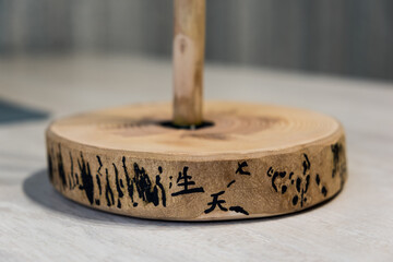 Paper towel holder, made with your own hands from wood, Ash. Beautiful wood texture. The pattern on the remains of the bark looks like hieroglyphs. Close-up.