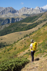 Fototapeta premium Woman walking in the Natural Park of the Western Valleys , Huesca Pyrenees
