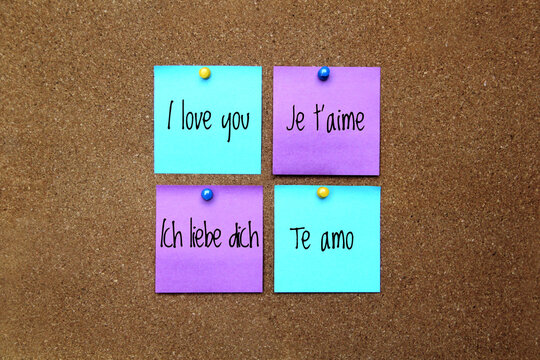Multicolor notes with important message, motivation and reminders on cork board "I love you" in different languages: English, French, Spanish, German