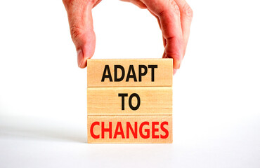 Adapt to changes symbol. Concept words Adapt to changes on wooden blocks. Businessman hand....