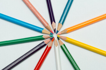 wooden color pencils isolated  in white background, rounded frame. Macro of colored pencils in a circle.