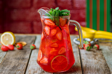 Strawberry lemonade with lime on wooden table side view - obrazy, fototapety, plakaty