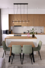 Scandinavian style cozy modern white kitchen interior with a dining zone, white modern interior in farmhouse style. nordic kitchen in loft apartment. 3D rendering. High quality photo