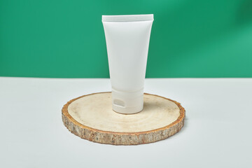 cosmetic product in tube, glass bottle, lotion, anti-aging moisturizer, facial essential oil or serum on green background with light shadow nature. Organic natural and Beauty skincare concept.