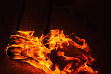 orange fire from an iron torch. Burning kerosene on a cane rag. burning staff on the stone floor....