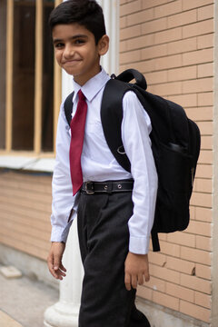 A smiling student leaving for school