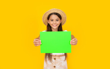 happy teen girl with copy space on green paper on yellow background