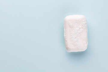 Soap bar and foam on white background, top view. Mockup for design