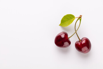 Cherry berries on a pastel background top view.  Background with a cherry on a sprig, flat lay