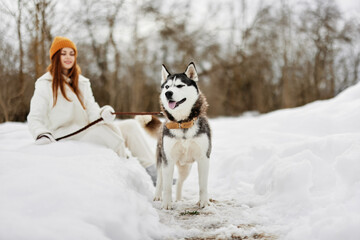 woman outdoors in a field in winter walking with a dog Lifestyle