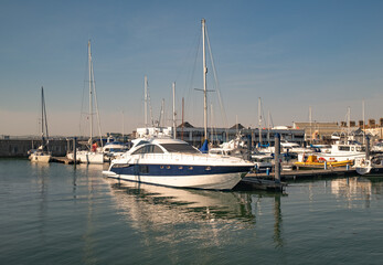 Fototapeta premium Boats and leisure craft moored up in Lowestoft marina and docks on the Suffolk coast. Captured on a bright and sunny morning