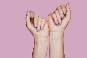 Blue winter nail art design on pink background