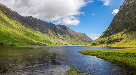 Naklejka na ściany i meble The scenic view of Loch Achtriochtan in Glencoe, ScotlandLoch Achtriochtan or Loch Trychardan is a small shallow freshwater loch located to the east of Glencoe village in Scottish Highlands.