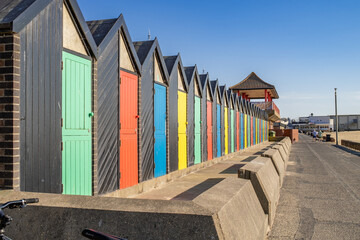 Colourful beach huts on Lowestoft promenade. Captured on a bright and sunny morning