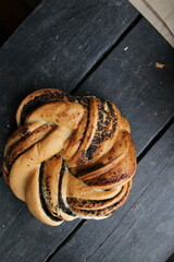 Sweet roll with poppy seeds On a beautiful wooden background