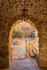 Fototapeta premium Arched way to inner yard of the Mor Hananyo Monastery in Mardin, Turkey