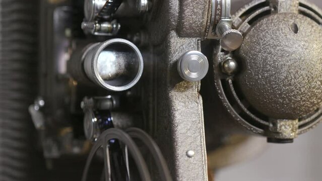 closeup of a vintage 8mm projector starting up