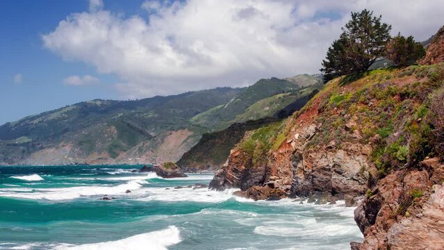 Cinemagraph of view of californian coast with blue sky and moving waves
